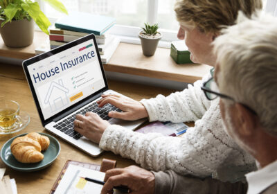 senior-couple-consulting-house-insurance-laptop